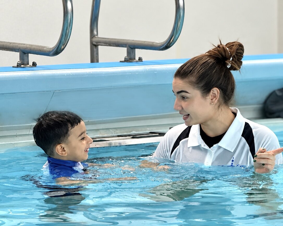 Ripple coach teaching a child in the pool